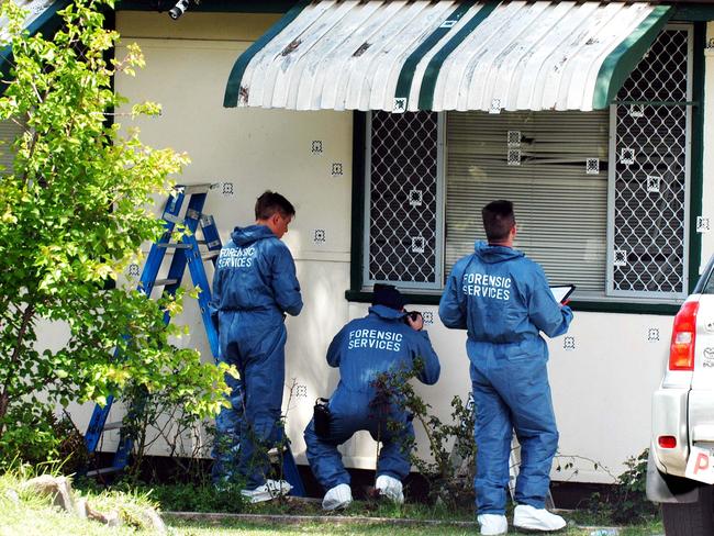 Forensic officers examine the scene after two people died in a hail of bullets fired at a house in Greenacre.