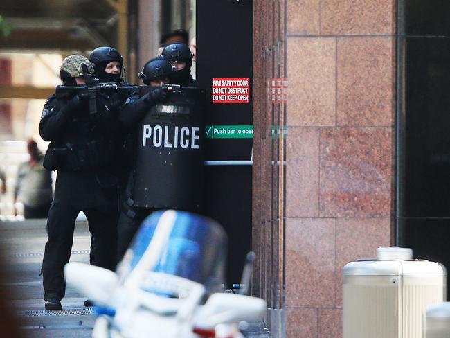 Heavily armed police outside the cafe during the first day of the Sydney siege. Picture: Toby Zerna