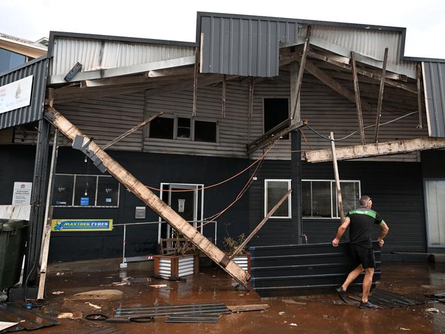 Grant McPherson from Maccas All Mechanical removes debris from his flood-affected Lismore business on March 2, 2022. Picture: Dan Peled