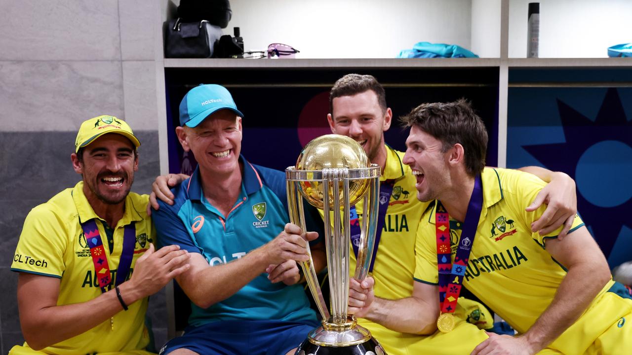 Mitchell Starc, Josh Hazlewood, Mitch Marsh and Andrew McDonald, Head Coach of Australia poses with the ICC Men's Cricket World Cup Trophy. (Photo by Robert Cianflone/Getty Images)