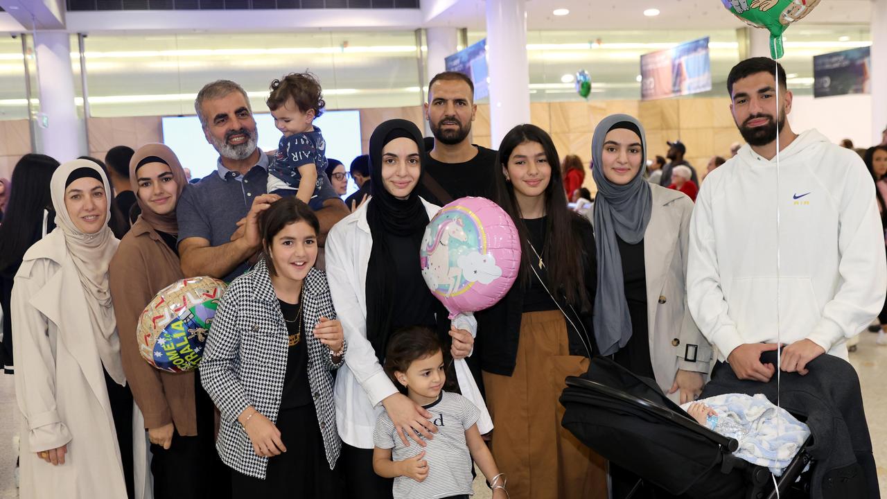 Sara and Khalil Elmasry and kids Houssum (1) and Aaliyah (4) and other family and friends pictured just after arriving at Sydney Airport after travelling from Gaza. Picture: Damian Shaw