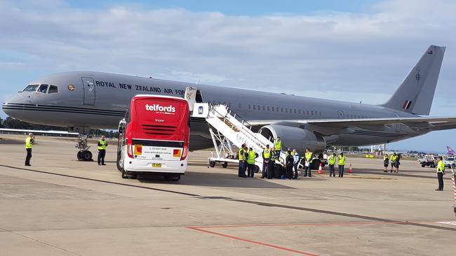 Harry and Meghan will fly out on this plane. The bus carrying New Zealand’s Invictus athletes is parked on the tarmac at Sydney Airport. Picture: Candace Sutton