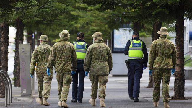 Police and ADF patrol in Melbourne. An ADF member has been fined over a hotel quarantine breach in Sydney. Picture: NCA NewsWire / Sarah Matray