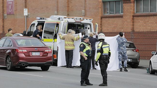 Paramedics and Tasmania Police investigators at the scene of today’s fatal accident in Davey St. Picture: MATHEW FARRELL