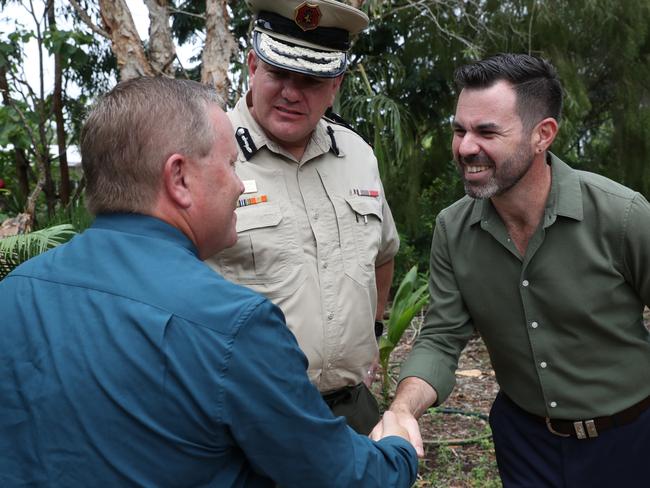 CDU Tafe chief executive Michael Hamilton shakes hands with Attorney-General Chansey Paech with Corrections Commissioner Matthew Varley after the announcement of a $1.7 per-year training partnership between the university and the prisons.