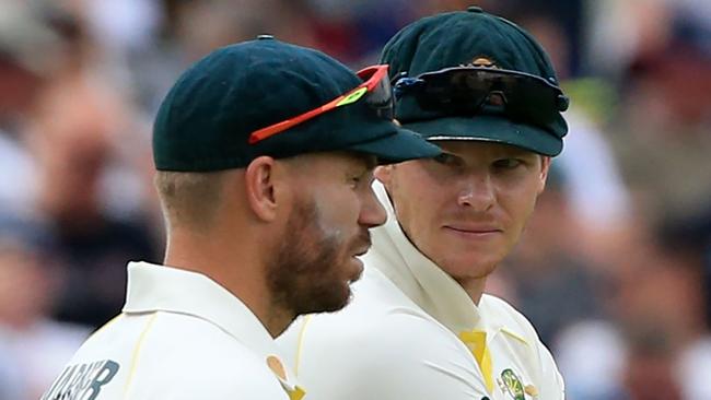 Ian Chappell says he can’t understand why Steve Smith (right) is allowed to return to an official leadership position but David Warner (left) is not. Picture: AFP