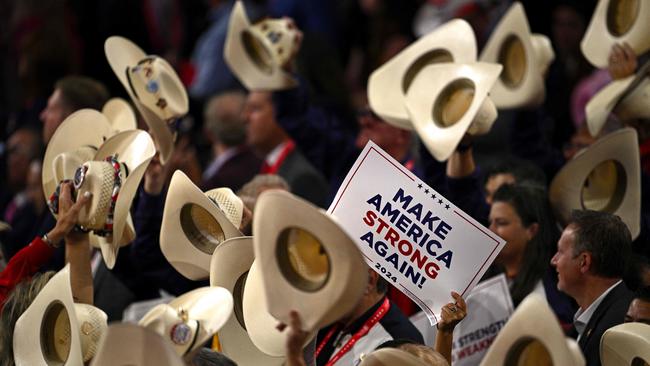 Delegates hold up their hats and signs during the third day of the 2024 Republican National Convention. Picture: Brendan Smialowski/AFP