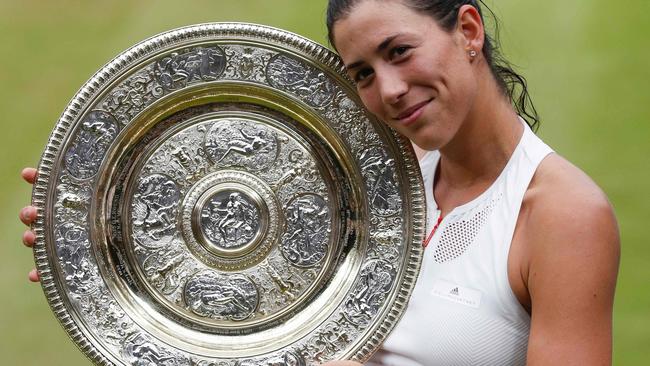 Spain's Garbine Muguruza poses with The Venus Rosewater Dish after winning the women’s singles final at Wimbledon. Picture: AFP