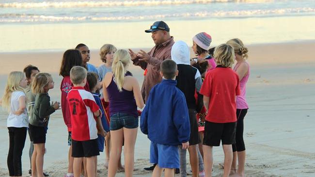 Joel Slabb, the founder of Juraki Surf Culture, with some of his young charges.