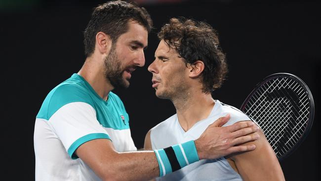 Rafael Nadal of Spain reacts after retiring against Marin Cilic in their quarter-final