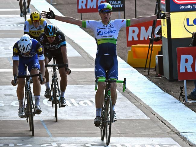 Australia’s Mathew Hayman celebrates as he crosses the finish line ahead of Belgium’s Tom Boonen.