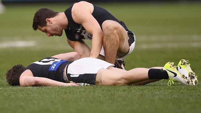 Matthew Wright checks on Jed Lamb as he lays unconscious. Picture: Getty