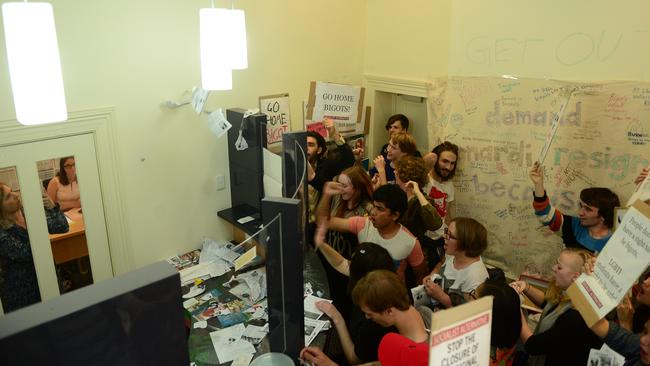 The protesters chant slogans as Senator Cory Bernardi's staff take shelter in another room. Picture: Mark Brake