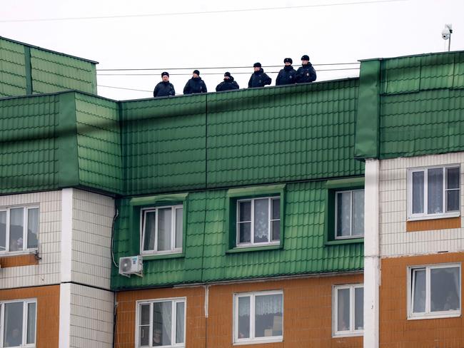 Police officers stand guard on the roof of an apartment building during the burial of late Russian opposition leader Alexei Navalny. Picture: AFP