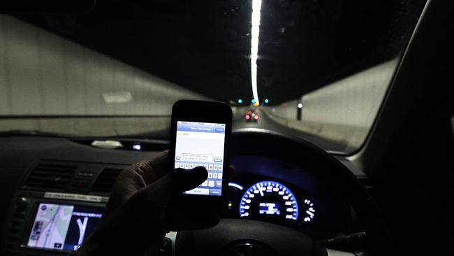 A man was busted using his mobile phone while driving.