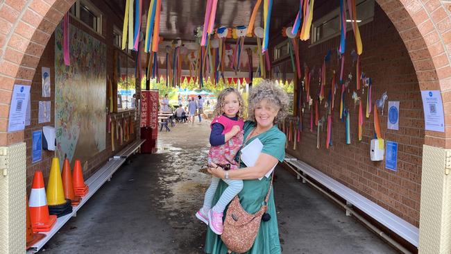 Upper Hunter Greens candidate Sue Abbott with her granddaughter going to the Scone Grammar School Fete whilst on the campaign trail. Supplied.