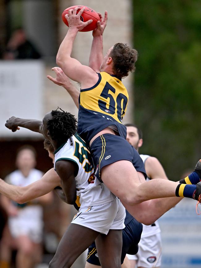 NFL: Hurstbridge’s Joel Naylor soars over Ayui Makiemg of Northcote Park. Picture: Andy Brownbill