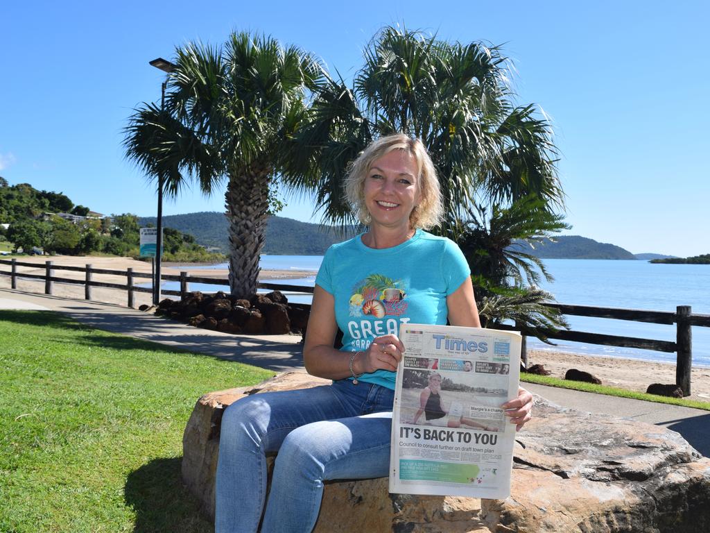 Margie Murphy holds up her front page from when she was named Whitsunday Women in Business Community Champion, in 2015, for her services to the Great Barrier Reef Festival as chairwoman.