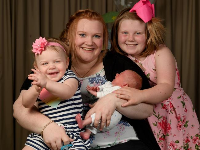 Jessica Logan with Angus at 34 weeks in December and his sisters Olivia, 19 months and Evie, 9. Photo: Naomi Jellicoe