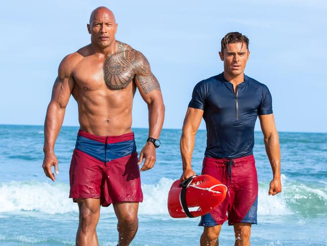 Dwayne Johnson’s Mitch and Efron’s Matt Brody come out of the surf.