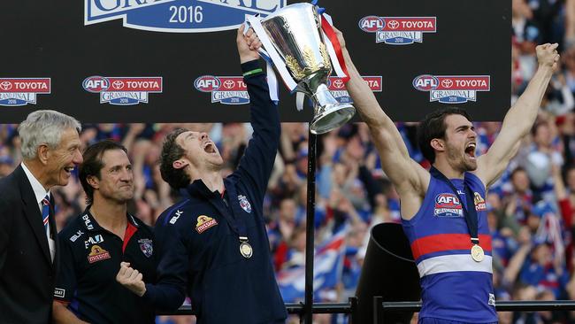 Bob Murphy and Easton Wood hoist the premiership cup as John Schultz and Luke Beveridge watch on. Picture: Wayne Ludbey