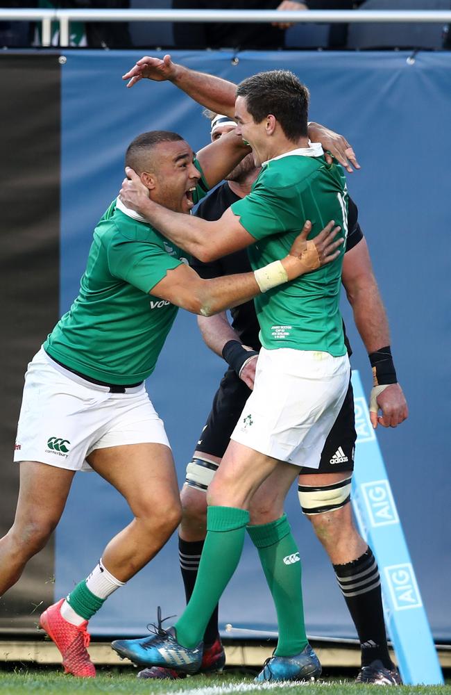Simon Zebo of Ireland celebrates with teammate Jonny Sexton after scoring his team’s fourth try.