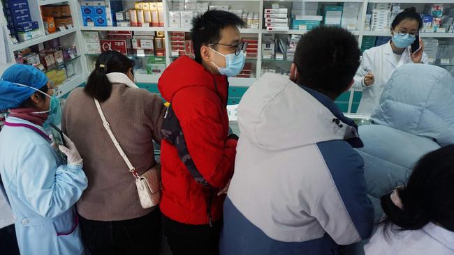 People queue to buy antigen test kits at a pharmacy in Hangzhou, in China's eastern Zhejiang province. Picture: AFP