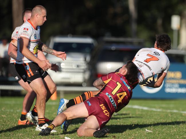 Daniel Payne is tackled by Ritchie Kilmister. Picture Warren Gannon Photography