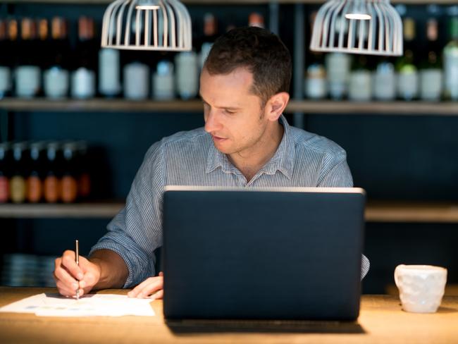 Business man doing the books at a restaurant - entrepreneurship concepts