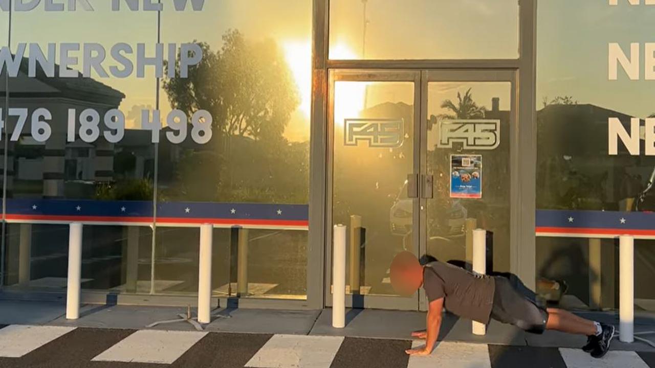 Jamie does a push up outside his shut down gym in Runaway Bay.