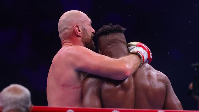 Britain's Tyson Fury embraces Francis Ngannou after their heavyweight boxing match. Photo by Fayez NURELDINE / AFP.