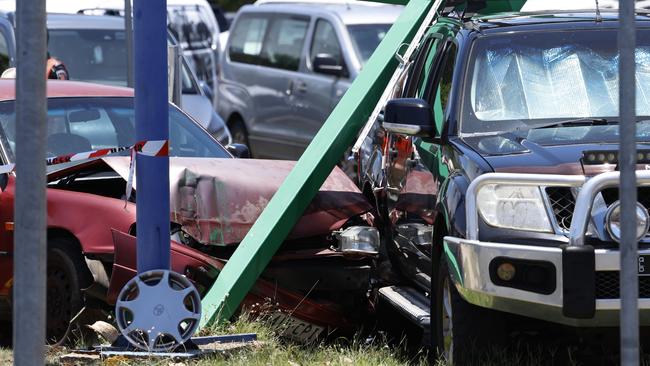 Queensland Fire and Emergency Services (QFES) personnel attend a single vehicle traffic crash at the intersection of Sheridan and Florence Streets, Cairns City, where an early model Toyota Camry struck a street sign and a parked ute. Picture: Brendan Radke