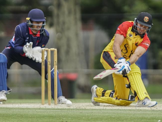 Dandenong keeper Aaron Fernando watches as St Kilda batsman Josh Manning sweeps. Picture: Valeriu Campan