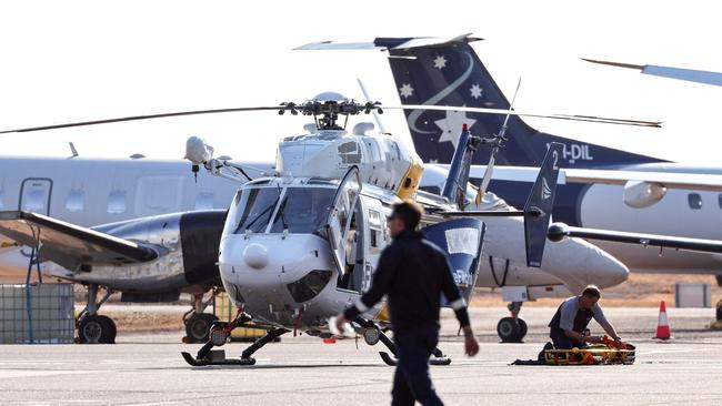 A Care Flight helicopter is seen on the tarmac of the Darwin International Airport in Darwin on August 27, 2023, as rescue work is in progress to transport those injured in the US Osprey military aircraft crash at a remote island north of Australia's mainland. Three US Marines died on August 27 after an Osprey aircraft crashed on a remote tropical island north of Australia during war games, US military officials said. (Photo by DAVID GRAY / AFP)