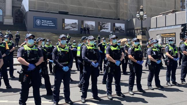 Police stand guard at an anti lockdown protest in Melbourne. Pictures: Brianna Travers