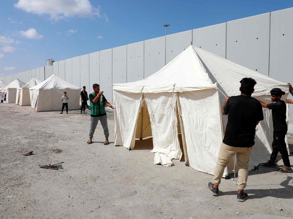 Volunteers set up tents along the Egyptian side of the Rafah crossing. Picture: Kerolos Salah/AFP