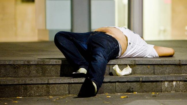 12/12/2009 NEWS: A drunk man passed out on steps in Castlereagh Street, Sydney city, as police put Operation Unite into effect, reclaiming the street from drunks, drug use and violence.