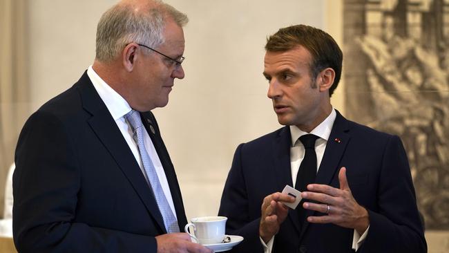 Emmanuel Macron, pictured with Scott Morrison, is in trouble and cannot afford to seem a weak promoter of French glory. Picture: Adam Taylor