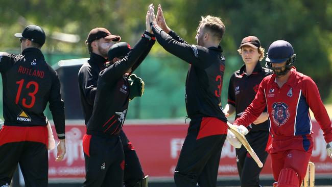 Matt Doric celebrates a wicket for Essendon. Picture: Hamish Blair