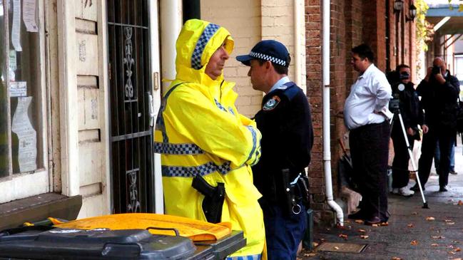 Police outside a two-storey terrace where 52-year-old Roslyn Reay was found murdered in 2005. Picture: Robert McKell