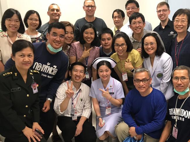 Photo: Dr Richard Harris from the Australian Medical Assistance Team and his diver partner, Craig Challen, with medical staff caring for the rescued children in Chang Rai hospital.  Also pictured is DFAT Crisis Response Team member, Michael Costa.Picture: Department of Foreign Affairs and Trade