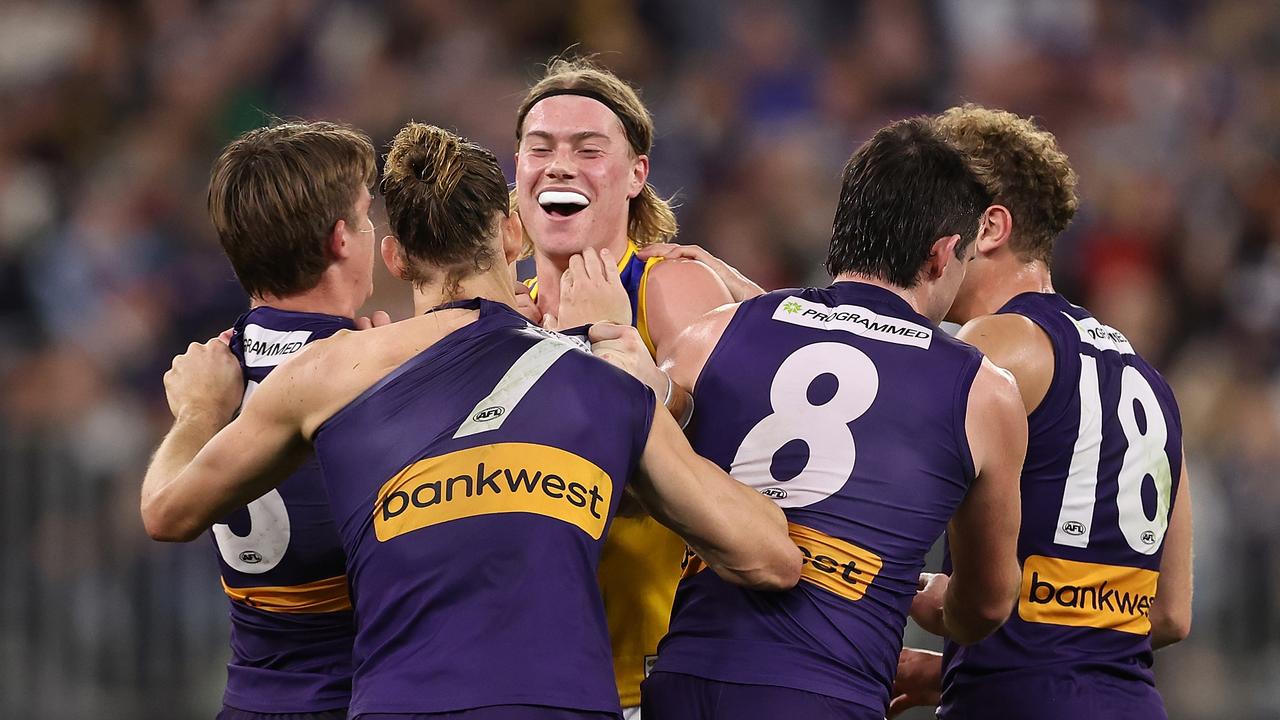 PERTH, AUSTRALIA - JULY 27: Harley Reid of the Eagles wrestles with Caleb Serong and Nat Fyfe of the Dockers during the round 20 AFL match between Fremantle Dockers and West Coast Eagles at Optus Stadium, on July 27, 2024, in Perth, Australia. (Photo by Paul Kane/Getty Images)