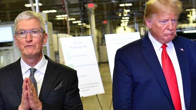 Apple CEO Tim Cook may want to do some praying to be shielded from Donald Trump’s planned new iPhone tariff. (Photo by MANDREL NGAN / AFP)