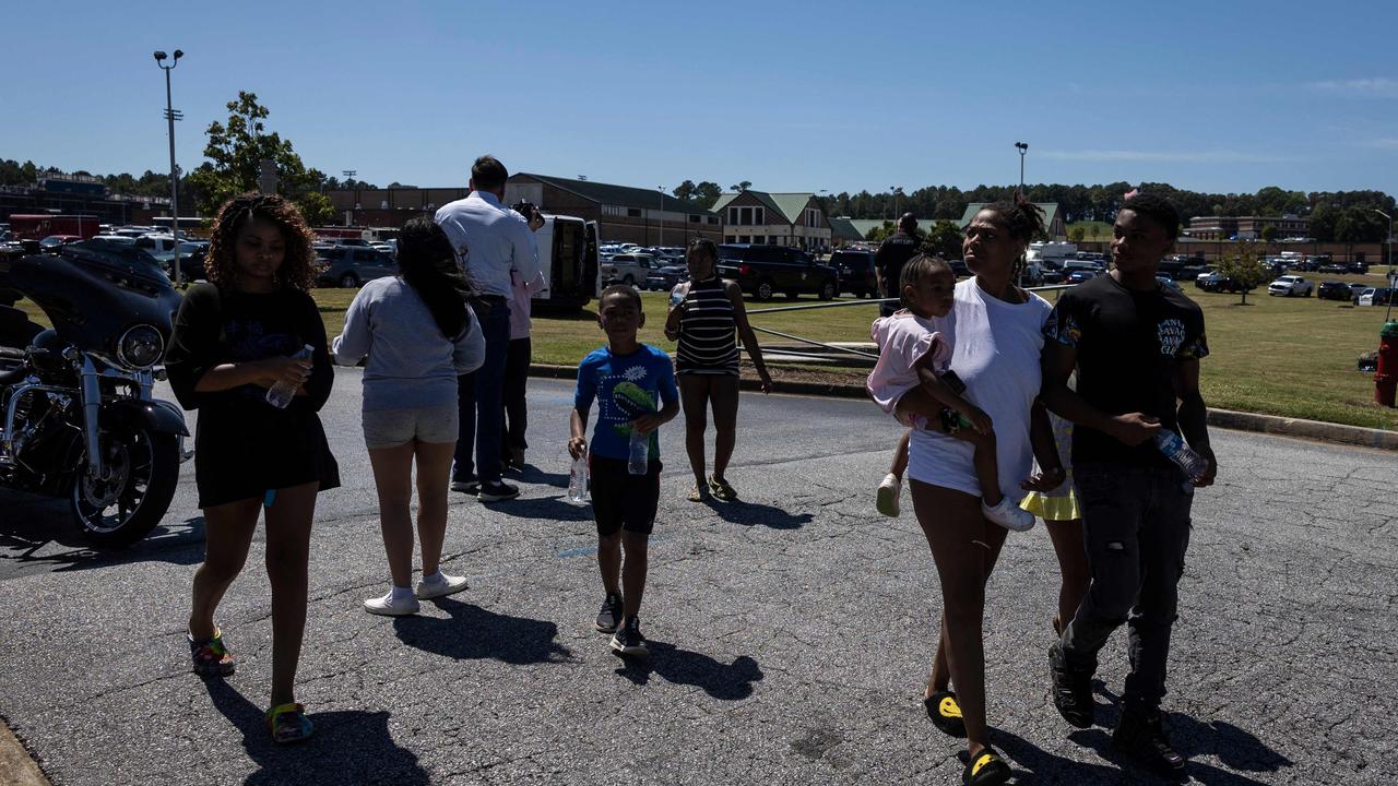 Parents and students leave the scene after being reunited after a shooting took place at Apalachee High School in Winder, Georgia, on September 4, 2024. (Photo by CHRISTIAN MONTERROSA / AFP)