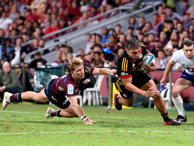 Chiefs halfback Cortez Ratima gets the better of Reds skipper Tate McDermott in scoring a try at Suncorp Stadium. Picture: Bradley Kanaris/Getty Images