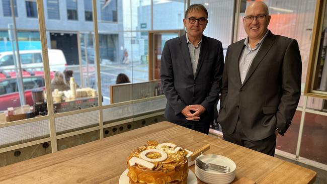 Tasmanian Chamber of Commerce and Industry Chair Wayne Davy and CEO, Michael Bailey with the TCCI's 100th birthday cake at Pigeon Whole Bakers in Hobart