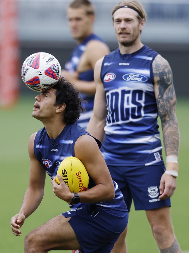 Lawson Humphries has his hands full with the round ball and oval ball during a Geelong training session last week. Picture: Michael Klein