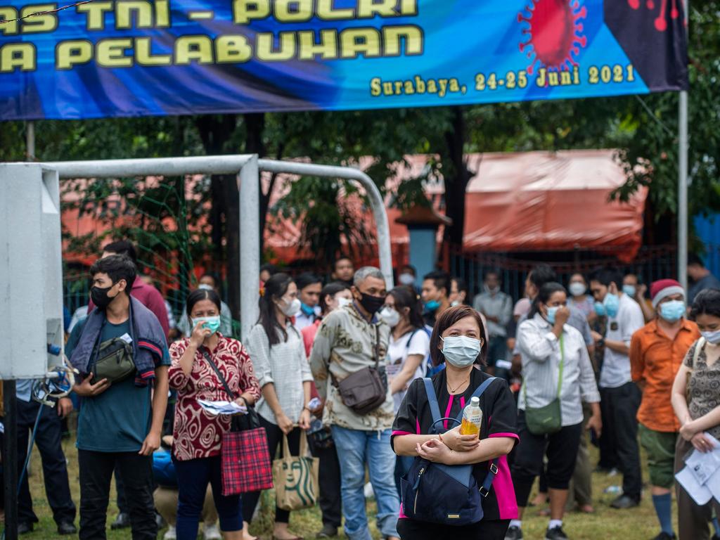 Residents wait to receive a dose of the Sinovac Covid-19 vaccine during a mass vaccination at a housing area in Surabaya. Picture: AFP