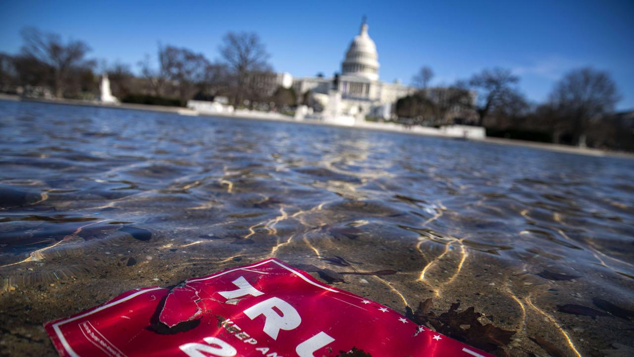 WASHINGTON, DC - JANUARY 09: A campaign sign for U.S. President Donald Trump lies beneath water in the Capitol Reflecting Pool, on Capitol Hill on January 9, 2021 in Washington, DC. A pro-Trump mob stormed and desecrated the U.S. Capitol on January 6 as Congress held a joint session to ratify President-elect Joe Biden's 306-232 Electoral College win over President Donald Trump. Al Drago/Getty Images/AFP == FOR NEWSPAPERS, INTERNET, TELCOS &amp; TELEVISION USE ONLY ==