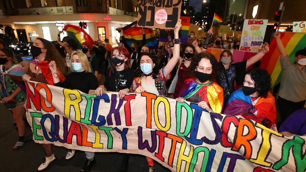 Protesters march as they hold signs during a rally against religious discrimination in Brisbane. Picture: Jono Searle/Getty Images